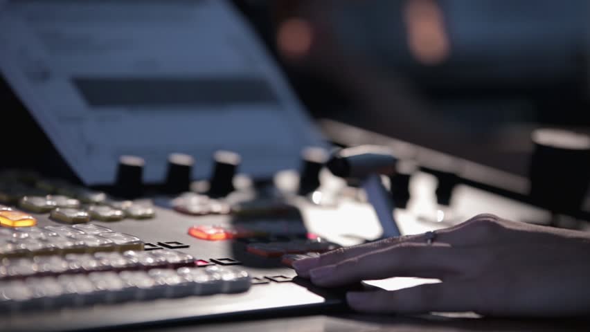 Television director during the live broadcast, switches cameras in the studio. Pushes the handle console in mobile television station telecruiser. | Shutterstock HD Video #9163805