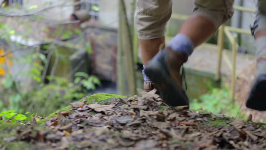Tourist couple going to look a local watermill. Slow motion RAW footage of a couple walking towards the water mill in the middle of a countryside on the sunny day.