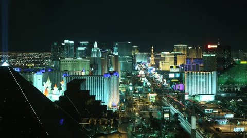 Time lapse Las Vegas at night from high above. All trademarks are blurred.  