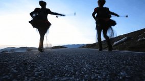 Women dancing and walking on asphalt