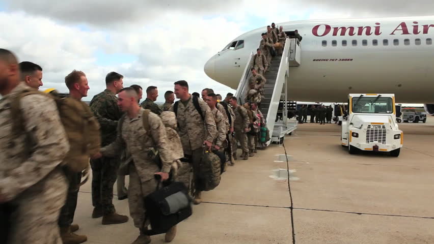 CIRCA 2010s - Soldiers return from deployment overseas to reunite with their families.
