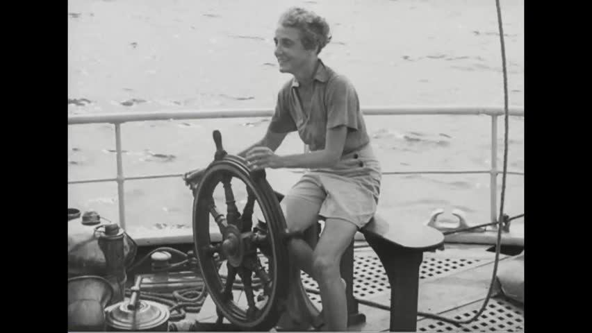 CIRCA 1930s - A boat sails around the Statue of Liberty in 1939.