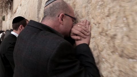 JERUSALEM, ISRAEL - FEBRUARY 08, 2015: Steadicam of believers religious Orthodox Jews pray at the Wailing Wall Jewish shrine in southern part of old city Jerusalem on Feb 08, 2015 in Western wall.