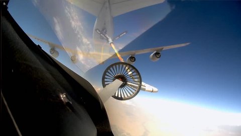 CIRCA 2010s - POV shots from the cockpit of a fighter plane as it is refueled in midair.