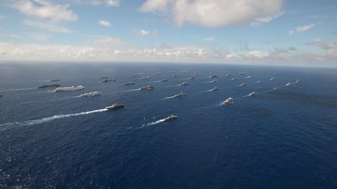 CIRCA 2010s - Aerial of massive flotilla of Navy ships on the move across the Pacific.
