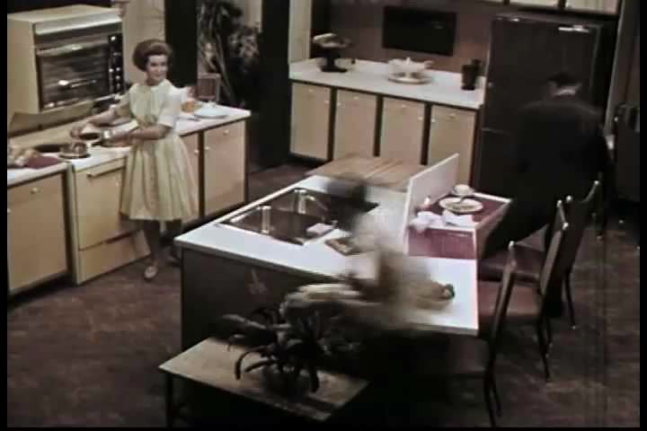 CIRCA 1960s - Family life in a 1960s kitchen. Equipped with modern space age appliances for ease and comfort