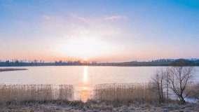 Frozen lake sunset. 4K timelapse footage