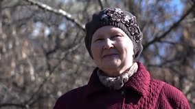 Close-up Portrait of Senior Pensioner Woman in the Park. 4K Ultra HD 3840x2160 Video Clip