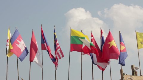 flags of asian countries against cloudy sky