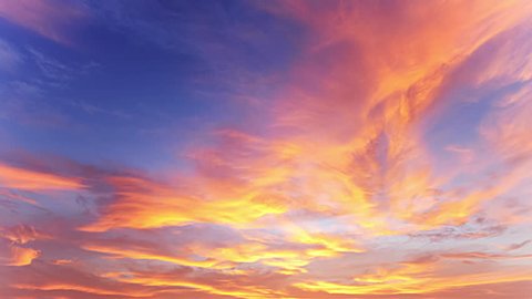 Beautiful sunset time lapse background. Clouds of yellow and golden orange color moving and changing fast at evening dawn