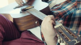 man playing acoustic guitar slow motion
