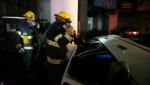 HAIFA, ISRAEL - MARCH 03, 2015: Firefighters use pneumatic cutter to evacuate  casualties from car accident in a tunnel full of smoke, during a drill of Haifa, Northern Israel Fire Brigade.