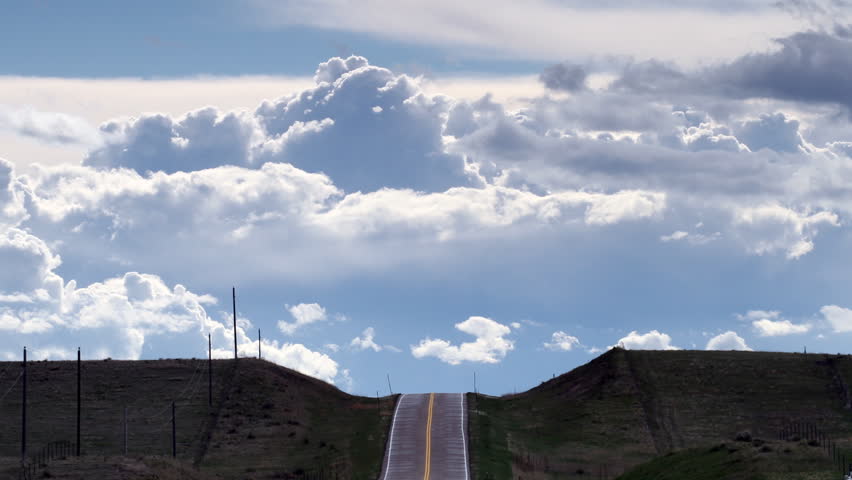 Surreal scene of a highway that seems to go into the sky, with storm clouds
