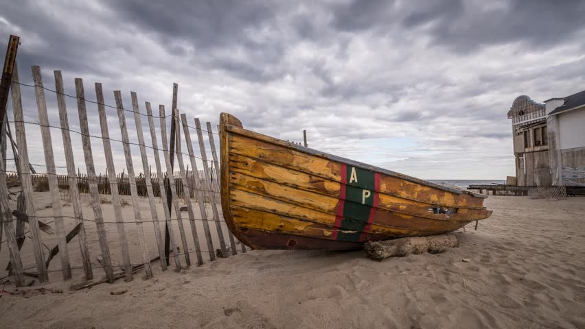 Asbury Park life guard boat wreckage.  A time lapse of clouds moving by on an ominous day post Hurricane Sandy.  