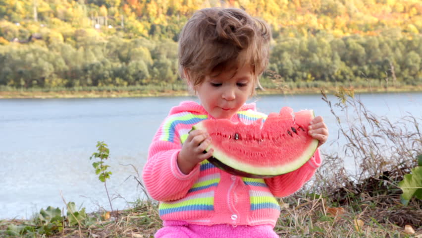 toddler eating ripe watermelon