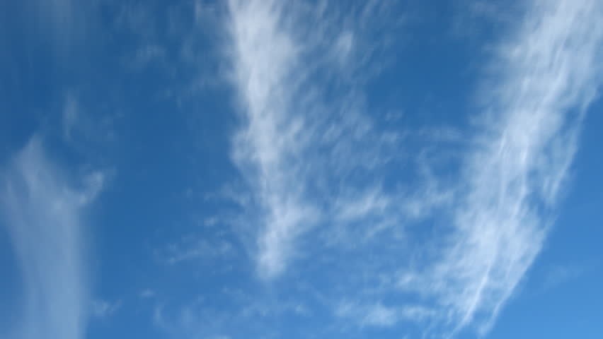 blue sky with moving fleecy clouds background