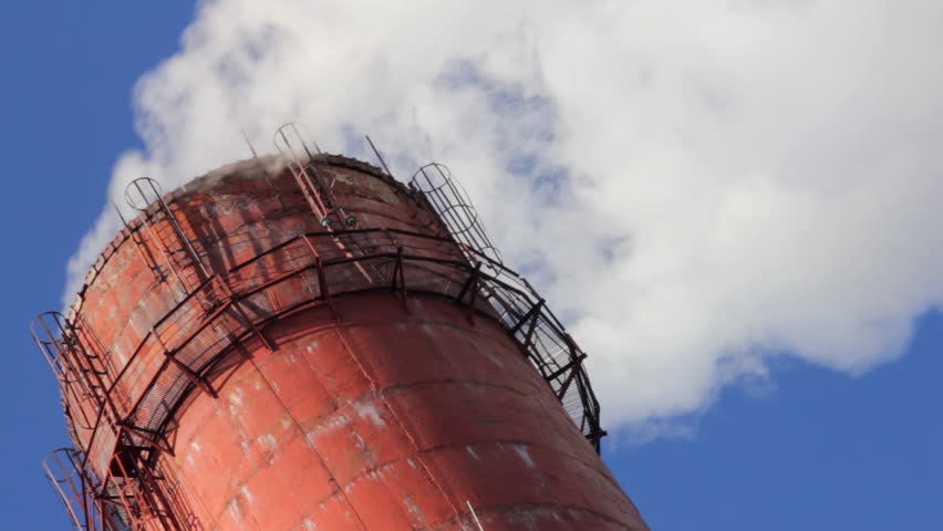factory chimney with smoke under blue sky - timelapse