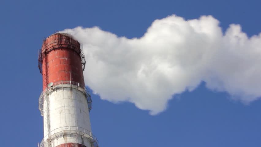 factory chimney with smoke under blue sky - timelapse