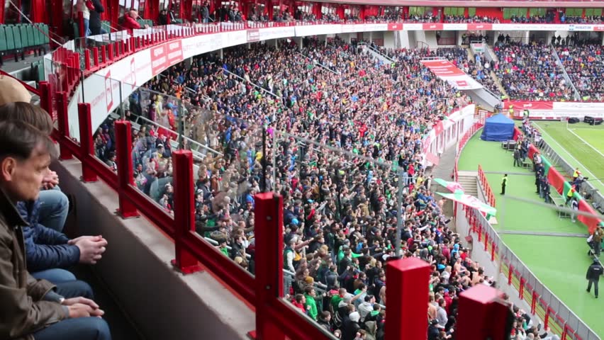 MOSCOW, RUSSIA - MAR 30, 2014: Fans chant at stadium Locomotive (match of Russian Premier League, Locomotive - Spartak )