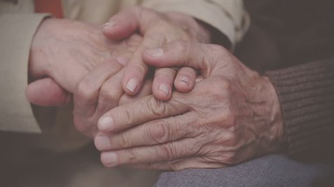 Extreme close up of elderly hands holding