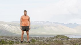 Fitness man jumping exercising outdoors doing jump squats in amazing nature landscape. Fit male athlete cross-training outside. Video from Iceland. RED EPIC, REAL TIME.