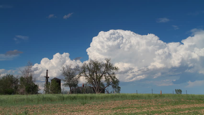 Large storm cell moves across the eastern Colorado sky, behind an old farm with