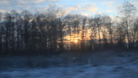 RUSSIA - 2012: Train window point of view. Winter. Sunset