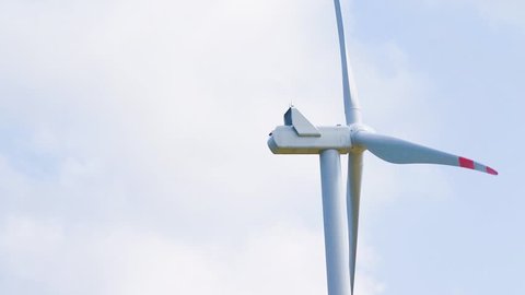 close-up of wind energy turbine are one of the cleanest, renewable electric energy source, under blue sky with white clouds