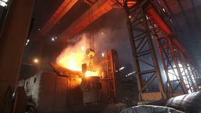 Foundry plants. Melting of the metal at the factory. The liquid metal is poured into the smelting stove. Splashes of molten metal at the plant.