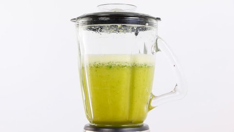 preparing green cocktail in blender