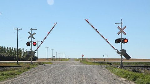 Rail crossing with sound of train coming. Gates lowering.
Rail crossing with sound of freight train coming. Kemnay, Manitoba.
