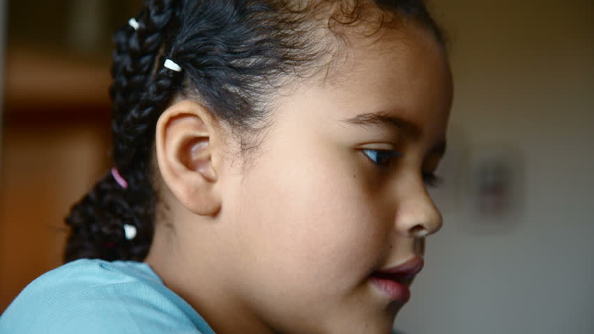 Portrait of a young mixed race girl smiling for the camera. Head shot. Close up. 