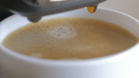 Coffee dripping in ceramic espresso cup 4K 3840X2160 UHD video - Coffee droplets falling on creamy espresso 4K 3840X2160 UHD footage