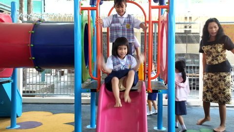 BANGKOK, THAILAND -  FEB 9, 2015: Unknown children in Children playing in the playground at Kindergarten School. Pieamsuwan school in bangkok at 2015, Children are happy.