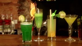 A lot of colorful cocktails on the bar. Camera motion, close up. HD 1080p.