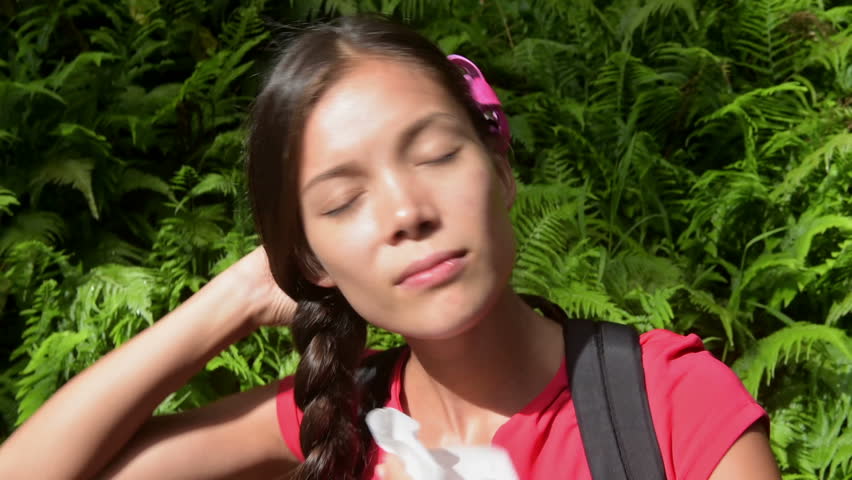 Mosquito repellent. Woman using paper wipes with insect repellent on skin outdoor in nature forest. Girl applying repeller to face.