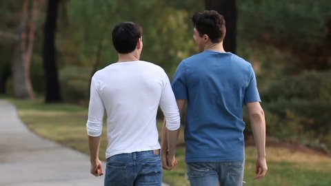 Two young, gay men walk down a path. Shot in Moreno Valley, Calif. in Feb. of 2014.
