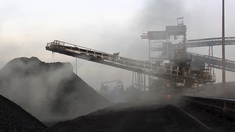 Coal stacker shrouded in smoke