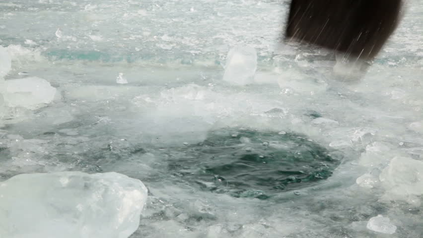 Hole in the ice 
Man with a shovel chops a hole in the ice that would get clean water 