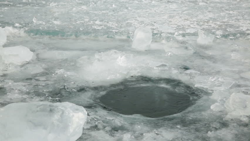 Hole in the ice 
Man with a shovel chops a hole in the ice that would get clean water 