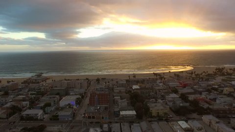 Los Angeles Aerial Venice Beach Sunset v89 Low flying aerial towards and over Venice beach during sunet.
