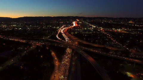 Los Angeles Aerial Freeway Interchange Dusk v73 Low flying aerial over freeway interchange of the 10 and 405 at dusk with heavy traffic.