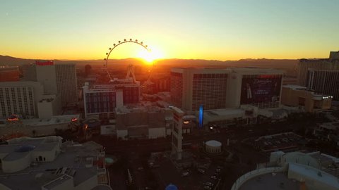 Las Vegas 2/18/15 Aerial Cityscape Strip Sunrise v31 Low flying aerial over strip towards and past high roller ferris wheel. 2/18/15