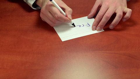 Hands writing the message Free on white notepaper. The business negotiations held in silence