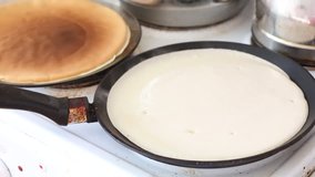 flour pancakes on a griddle