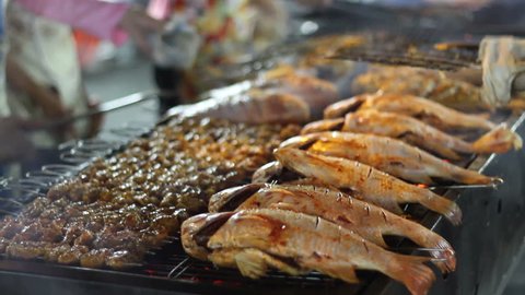 Fish on a charcoal grill in Saigon outdoor restaurant