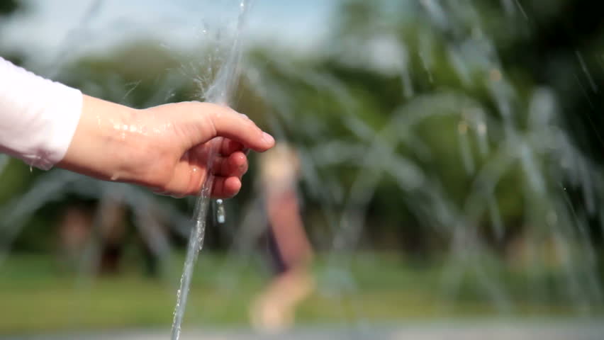 Child's hand splashing in the jets of the fountain in the summer closeup | Shutterstock HD Video #9293708