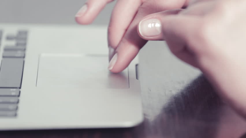 Woman's hand using and clicking a portable computer trackpad tight shot Royalty-Free Stock Footage #9300686