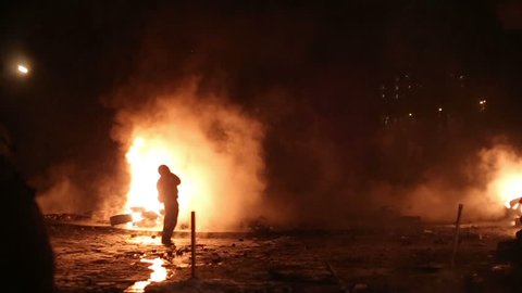 UKRAINE, KIEV, JANUARY 19, 2014: Thousands of anti-government protesters clashed with riot police, burning police buses and attacking with stones, sticks and fires after tough laws were passed