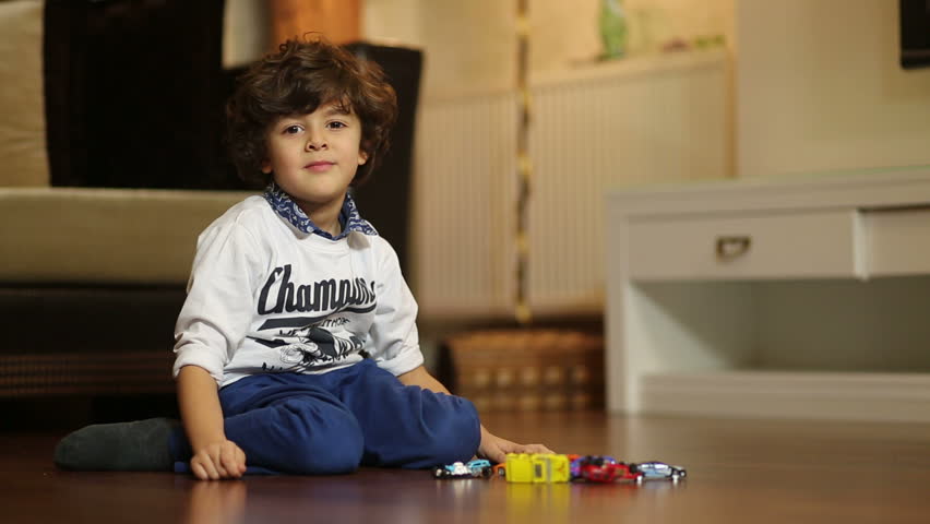 little boy is playing with car